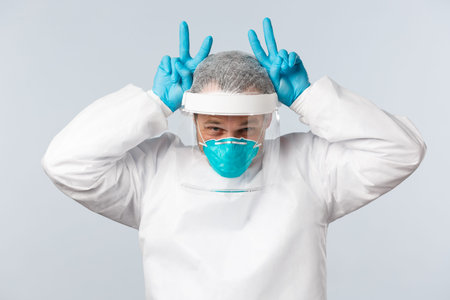 Covid-19, preventing virus, healthcare workers and vaccination concept. Happy optimistic doctor in...