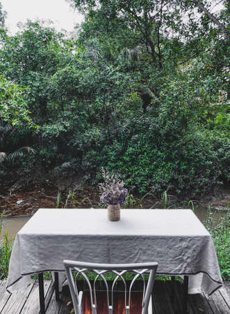Cafe tables and chairs outside with local tropical background.の写真素材