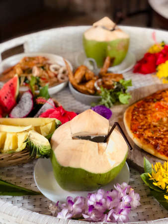 Tropical breakfast on floating tray. Fresh fruits, pineapple food and cold beverages.の写真素材