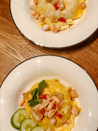 Close up Lava Omelette on top with shrimp Served on steamed rice In a white circular dish Looks...