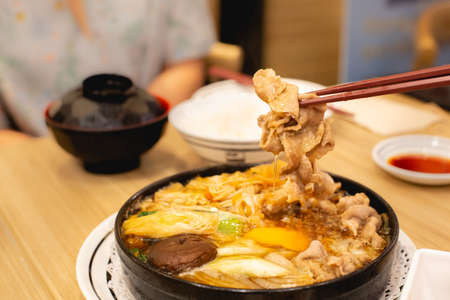 Two people are eating pork shabu or hot pot. Family time.の写真素材