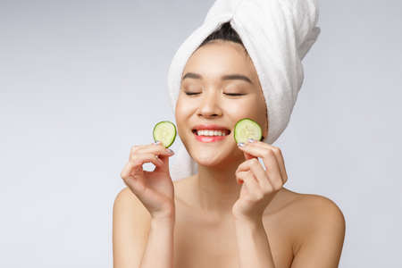 Beauty young asian women skin care image with cucumber on white background studio.の写真素材