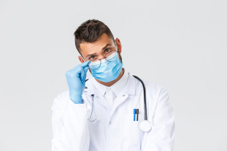 Covid-19, healthcare workers, pandemic and preventing virus concept. Close-up of serious-looking...