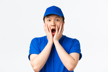 Online shopping, fast shipping, employees and home delivery concept. Close-up of amazed and wondered...