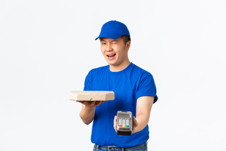 Contactless shopping, payment and delivery concept. Cheerful friendly, smiling asian courier in blue...