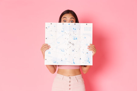 Travelling, lifestyle and tourism concept. Portrait of cute and excited asian girl explore new...
