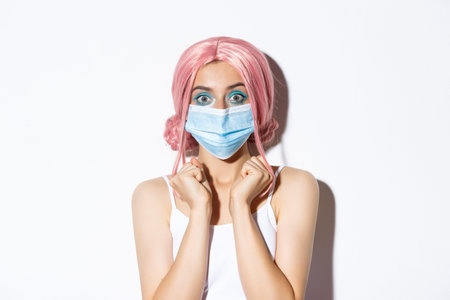 Coronavirus, social distancing and lifestyle concept. Close-up of excited attractive girl in pink...