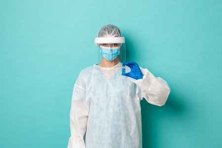 Concept of coronavirus, healthcare and quarantine. Image of female doctor in personal protective...