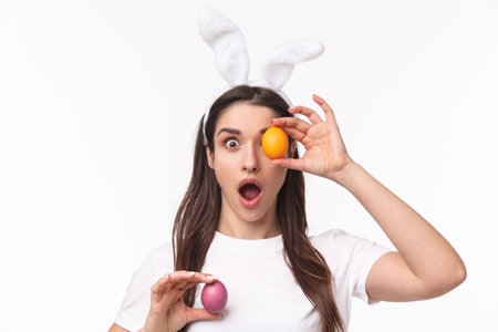 Easter, holidays and spring concept. Close-up portrait of amused, enthusiastic young woman in rabbit...