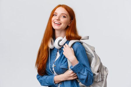College life, modern lifestyle and education concept. Cheerful good-looking redhead female student...