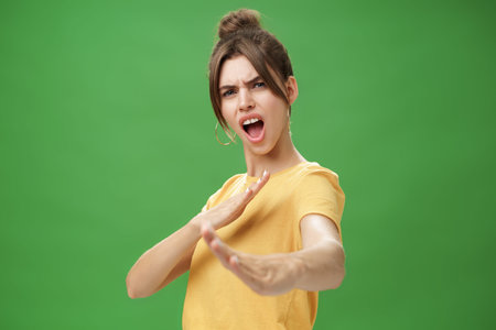 Not mess with this girl. Portrait of funny and emotive charismatic young woman standing in martial...