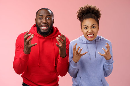 Two siblings upset failure losing bet watching football match cringing sorrow reckless, raising...