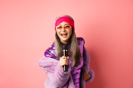 Fashion and lifestyle concept. Beautiful middle-aged woman in sunglasses, party dress and faux fur...