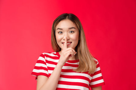 Cute friendly cheerful asian girlfriend sharing secret gossiping, smiling promise not tell secret...