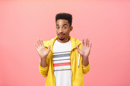 Guy staying out of troubles. Portrait of confused unsure clueless african american guy with beard...