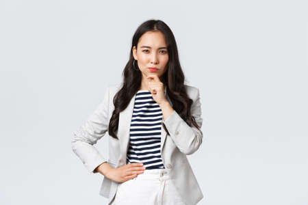 Business, finance and employment, female successful entrepreneurs concept. Serious-looking thoughtful elegant businesswoman thinking, making decision as looking at you ponderingの写真素材