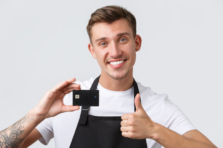 Cafe and restaurants, coffee shop owners and retail concept. Cheerful handsome salesman, store clerk...