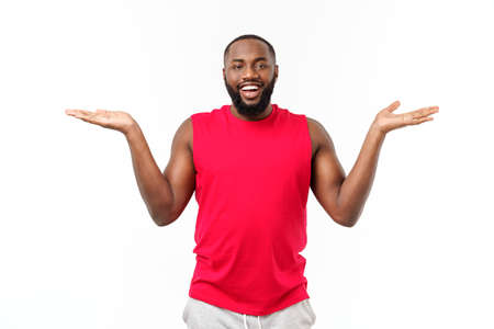 Young sport african american man extending hands to the side for inviting to comeの写真素材