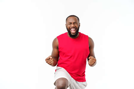 Young fitness african black man in sport wear cheering carefree and excited. Victory concept.の写真素材