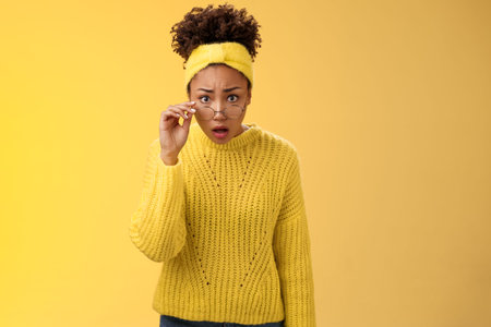 Shocked amazed african-american female student drop jaw gasping concerned confused take-off glasses...