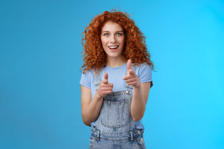 Gotcha. Cool sassy good-looking redhead curly woman pointing camera finger pistols cheeky...