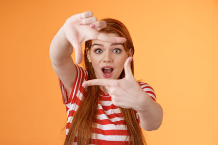 Creative upbeat redhead female student got inspiration, imaging how capture interesting shot, extend...