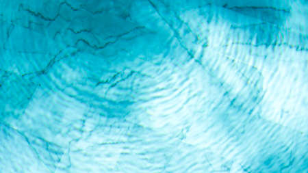 water swimming pool texture and surface water on pool, reflection blue wave nature water on the outdoor swimming poolの写真素材
