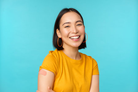 Vaccine campaign from covid-19. Happy and healthy asian girl laughing after vaccination from...
