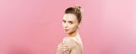 Beauty Concept - Beautiful Caucasian woman with clean skin, natural make-up isolated on bright pink background with copy space.の写真素材