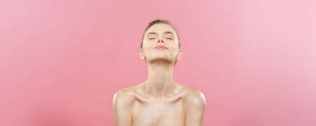 Beauty Concept - Beautiful Woman with Clean Fresh Skin close up on pink studio. Skin care face. Cosmetology.の写真素材