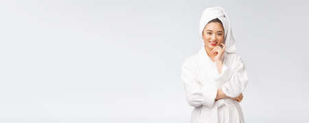 Spa skincare beauty Asian woman drying hair with towel on head after shower treatment. Beautiful multiracial young girl touching soft skinの写真素材