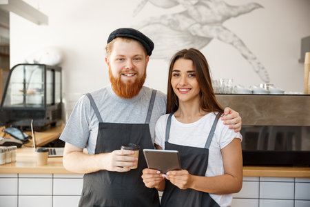 Coffee Business Concept - Portrait of small business partners standing together at their coffee shopの写真素材