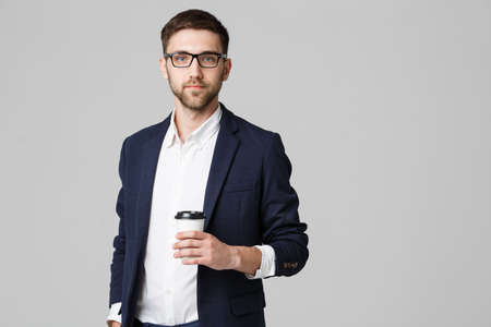 Portrait of a handsome businessman in eyeglasses with a cup of coffee.の写真素材