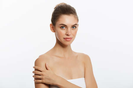 Youth and Skin Care Concept - Beauty Woman face Portrait. Beautiful model Girl with Perfect Fresh Clean Skin. Isolated on white background.の写真素材