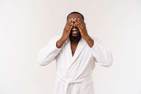 Young african american man wearing bathrobe over isolated white background thinking looking tired and bored with depression problems.の写真素材