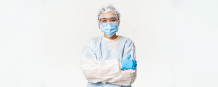 Female asian doctor or nurse in ppe, personal protective equipment from coronavirus, standing ready...
