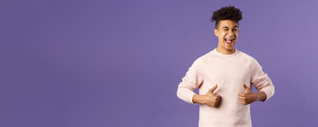 Portrait of enthusiastic lively, attractive young guy winking encourage join team, start career at...
