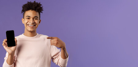 Close-up portrait of young handsome man promoting smartphone app or shopping online, internet...