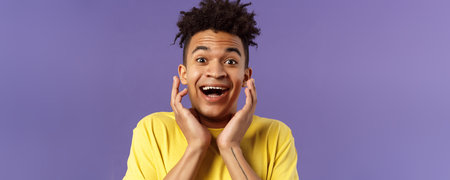 Close-up portrait of extremely happy, enthusiastic young man hear fantastic news, looking surprised...