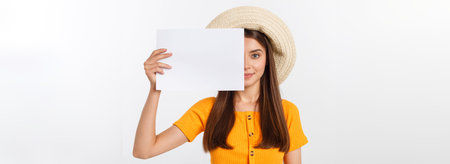 Happy business woman holding big white sign board. Gray wall back