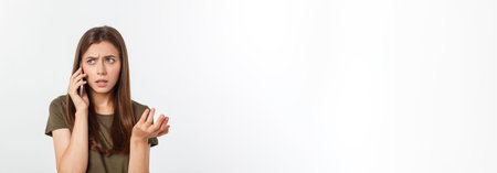 Worried young woman looks nervously, Female is nervous while talking on the phone, feels frustrated and worrying phone talk conceptの写真素材