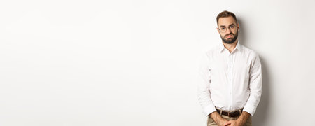 Sad and gloomy office manage frowning, standing tired against white backgroundの写真素材