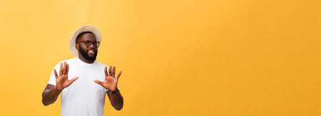 Portrait shock and annoyed displeased young man raising hands up to say no stop right there isolated orange background. Negative human emotion, facial expression, sign, symbol, body languageの写真素材
