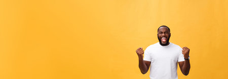 Handsome young Afro-American man employee feeling excited, gesturing actively, keeping fists...
