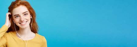 Lifestyle concept - Portrait of cheerful happy ginger red hair girl enjoy listening to music with...