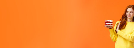 No thanks, dont want. Cute redhead girl trying resist temptation take bite delicious sweets, holding tasty cake and showing stop, refusal or rejection with grimacing face, express aversion, dislikeの写真素材