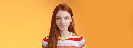 Attractive young sincere redhead girl clean pure perfect skintone smiling modest look camera...
