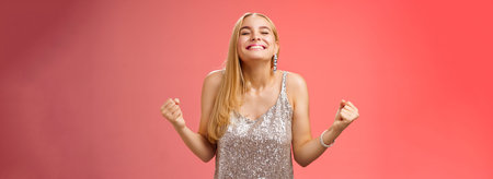 Sweet taste win. Charming happy blond girl rejoicing triumphing raise head up close eyes smiling...