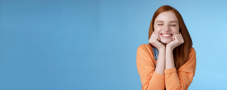 Silly cute happy redhead girlfriend smiling broadly close eyes dreamy squeez cheeks delighted asked...