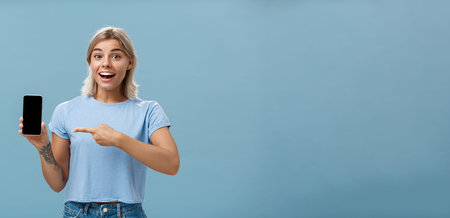 Waist-up shot of thrilled and impressed good-looking female student in casual t-shirt smiling...